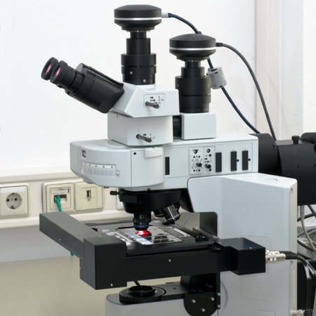 Modern high throuput fluorescent microscope scanning several biopsy samples