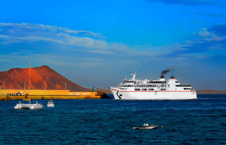 Ferry boat approaches pier at Corralejo harbour; Fuerteventura, Canary islands, Spainの写真素材