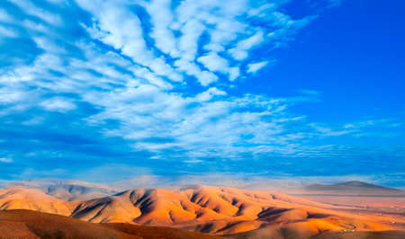Fuerteventura, rocky volcanic mountains with cloudy skyの写真素材