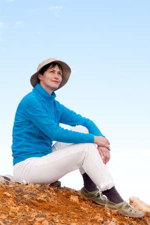 traveller rests on the mountain slopeの写真素材