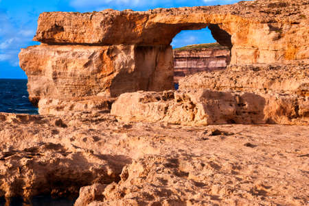 Azure window, natural stone arch by Dwejra cliffs at western Gozo island, Malta の写真素材