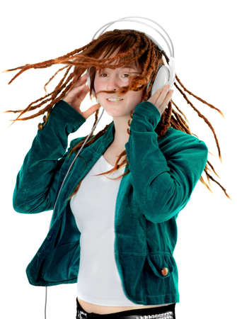 Young woman wearing earphones listens to the musicの写真素材