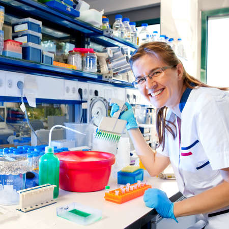 Scientist with multichannel pipetteの写真素材