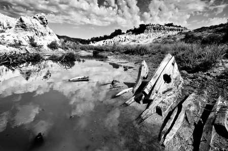 Small lake with remains of abandoned boat among sandstone cliffs in Sithonia, Chalkidiki, Greeceの写真素材