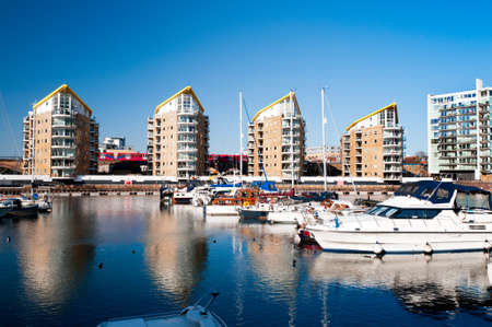 DLR train passing Limehouse Basin in East London, linking Regentのeditorial素材