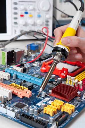 Service worker soldering electronic surcuit connectionの写真素材