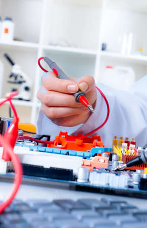 Tech tests electronic equipment in service centreの写真素材