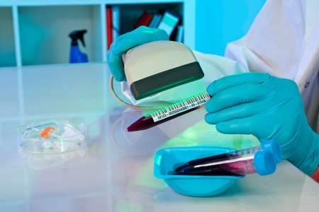 Tech scans barcodes on medical samples の写真素材