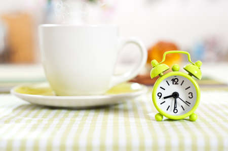 Clock on table laid for breakfastの写真素材