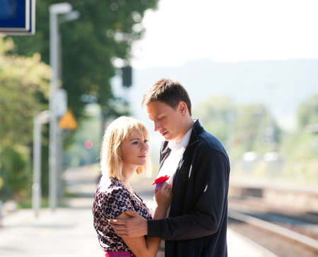 Young girl on train station says goodbye before catching her trainの写真素材