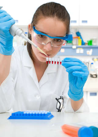 Young scientist holds stripe of samples for DNA amplificationの写真素材