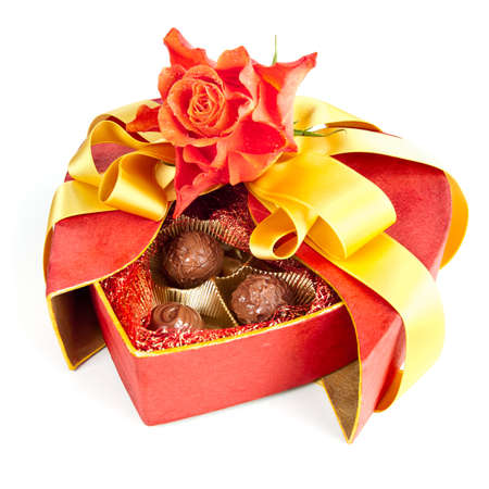 Decorated chocolate box in a shape of a heart with a rose on white backgroundの写真素材