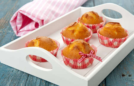 Breakfast tray with muffins on a table outdoorsの写真素材