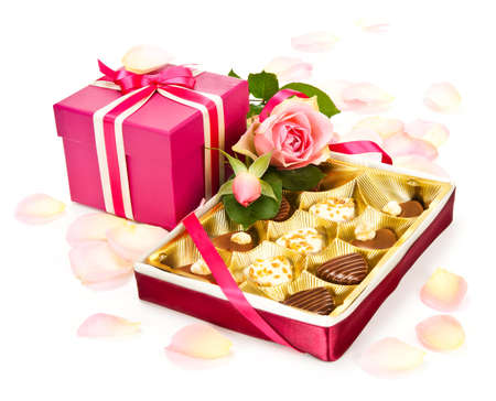 Box of chocolate pralines, rose and a pink gift box for Valentineの写真素材