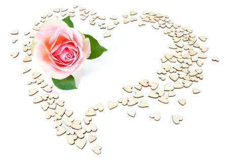 Pink rose in a heart shape made of smaller cardboard heartsの写真素材
