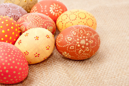 Colored Easter eggs on a rough sackcloth, copyspace