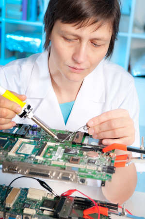 Tech tests electronic equipment in service centreの写真素材