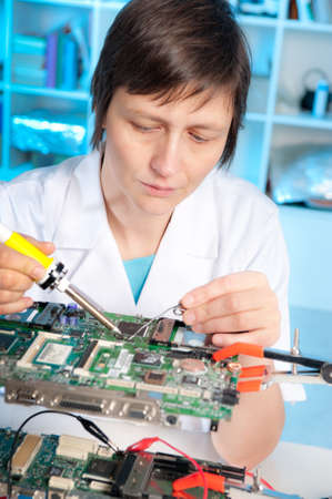 Tech tests electronic equipment in service centreの写真素材