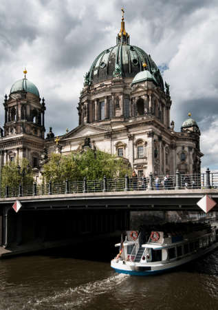 Berlin Cathedral and passenger boat on river Spreeの写真素材