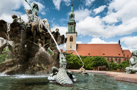 Neptune fountain in front of the St Mary Church in Berlinの写真素材