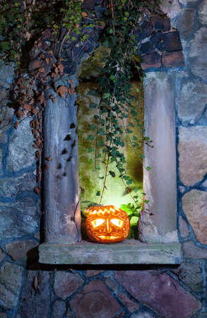 Jack o'Lantern on the blind window board on the Halloween eveningの写真素材