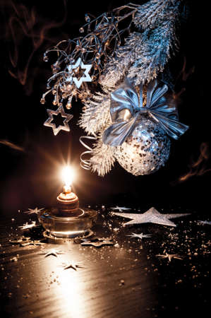 White and silver Christmas decorations, candle on a table の写真素材