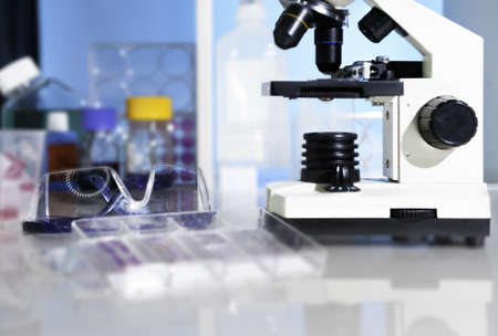 Entry level miicroscope and plastic safety glasses in scientific labの写真素材