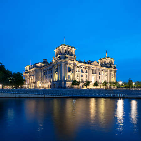 The Reichstag building  Bundestag  with reflection in river Spree at nightのeditorial素材