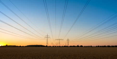 pylons on the fields in the sunsetの写真素材