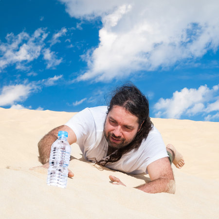 Thirsty man in the desert reaches for a bottle of pure water 
