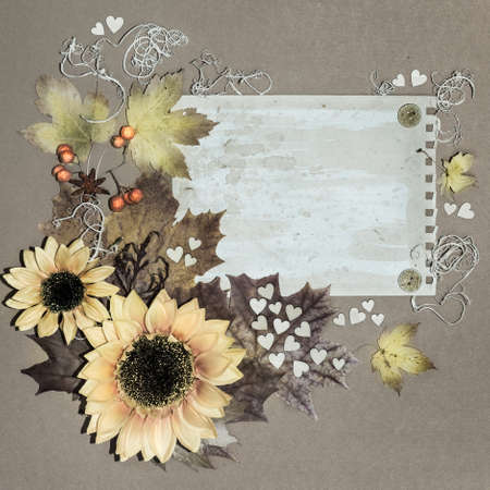 Autumn flowers and leaves arranged around textured paper, tinted image, spaceの写真素材
