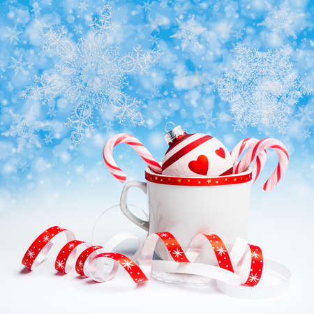 Red and white Christmas decorations on abstract winter backgroundの写真素材