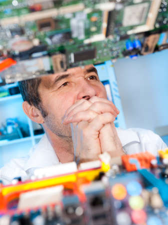 Senior radioelectronics repairman deep in thoughtの写真素材