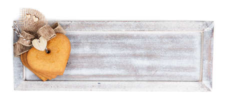Wooden board with decorated gingerbread cookies on white background, text spaceの写真素材