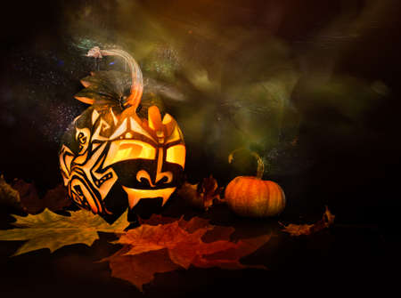 Halloween pumpkin with candle inside on black background, light brush technique の写真素材
