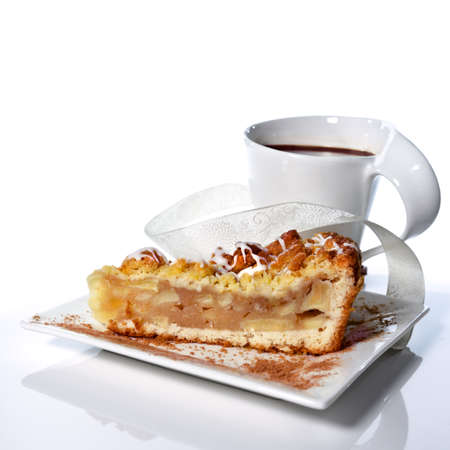 Grated Apple Pie with cup of coffee on white table with reflectionの写真素材