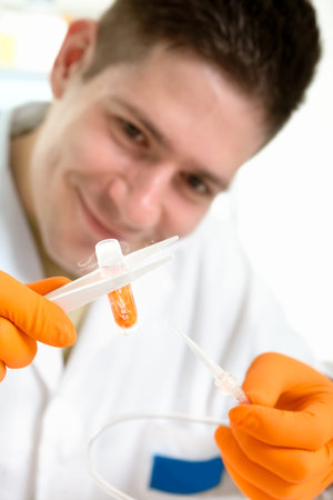 Young scientist holds cryosample in forceps