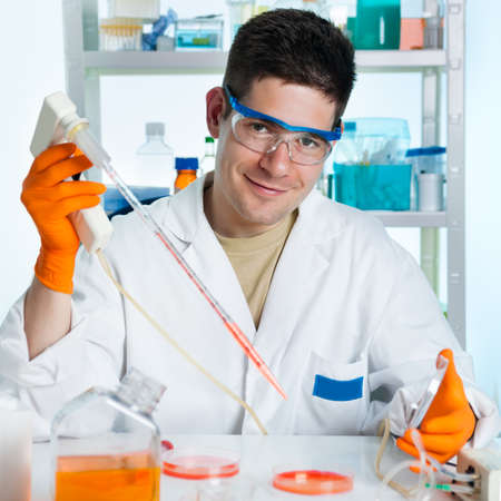 Young energetic scientist works with cultured cellsの写真素材