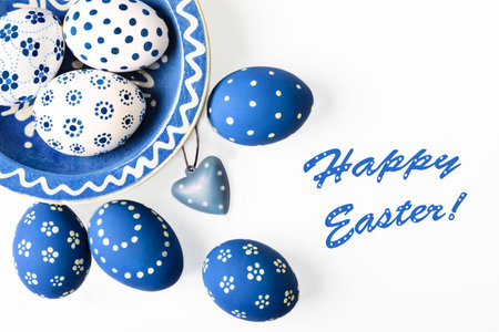 Ester eggs painter blue and white on white background, space