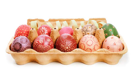 Crate with painted Easter Eggs on white background の写真素材