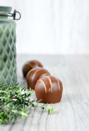Chocolate pralines on wooden table, text spaceの写真素材