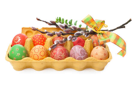 Crate of Easter Eggs with bunch of cat paws on top on white の写真素材
