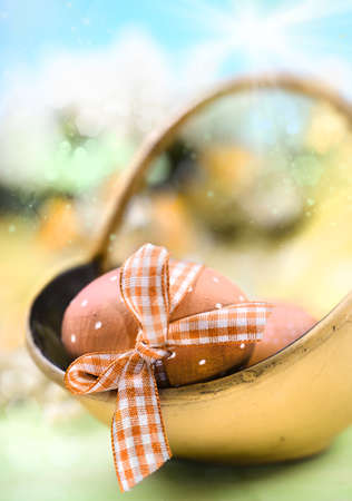 Easter with decorated egg in focus, shallow DOF の写真素材