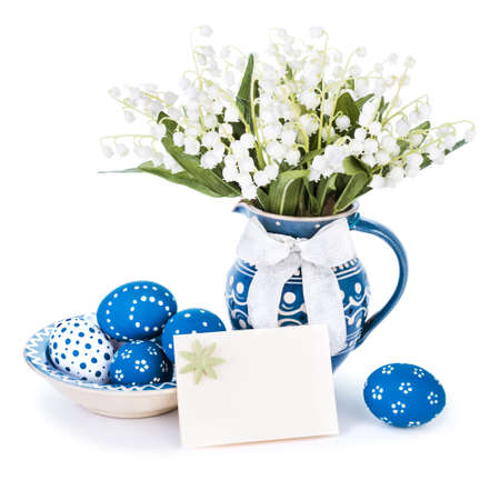 Easter eggs painted blue and spring flowers in matching vase on white  の写真素材