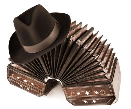 Bandoneon and a male hat on white backgroundの写真素材