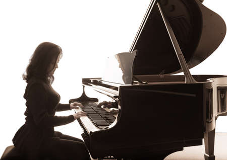 Young musician plays the grand piano, square compositionの写真素材