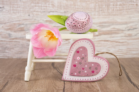 Easter decorations  wooden heart, painted egg and a tulip