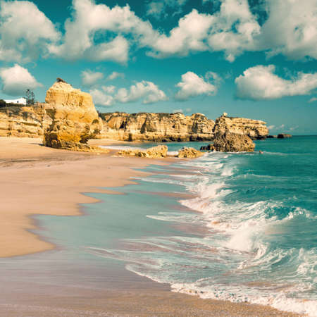 Golden beaches and sandstone cliffs near Albufeira, Portugal  Tinted imageの写真素材