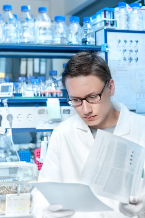 Young scientist or tech works in modern laboratory