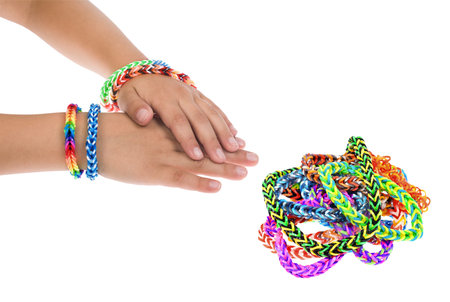 Loom rubber bracelets on a young childの写真素材